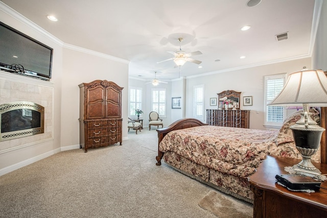 carpeted bedroom featuring ceiling fan, a fireplace, and ornamental molding