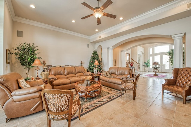 tiled living room with ceiling fan, ornamental molding, and decorative columns