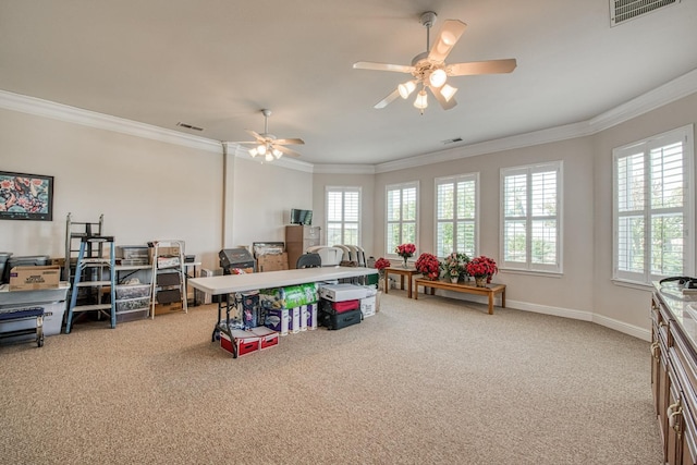 recreation room with ornamental molding, ceiling fan, and carpet floors