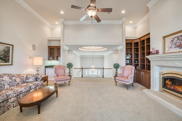 living room featuring light colored carpet, ceiling fan, and ornamental molding