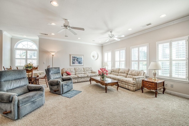 carpeted living room featuring crown molding, a wealth of natural light, and ceiling fan