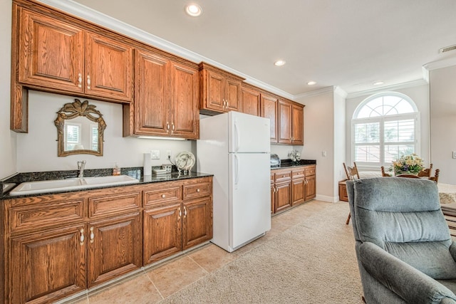 kitchen with ornamental molding, white refrigerator, sink, and light tile patterned flooring