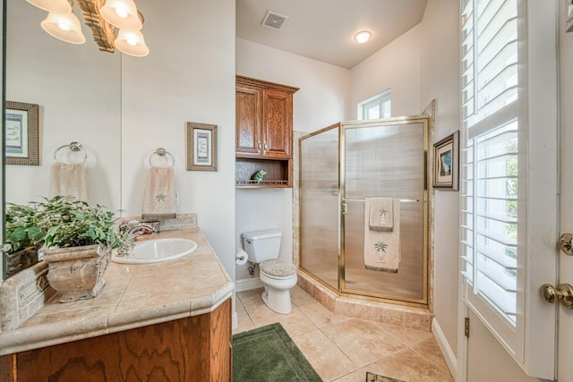 bathroom with tile patterned flooring, vanity, toilet, and walk in shower