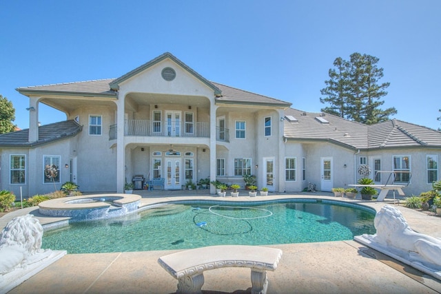 view of pool featuring an in ground hot tub, french doors, and a patio area