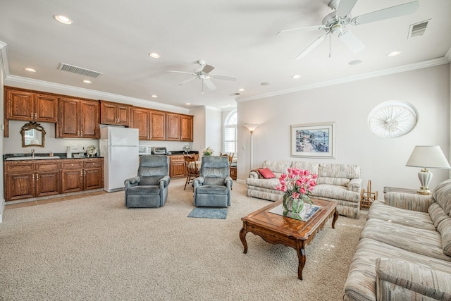 carpeted living room featuring ceiling fan and ornamental molding