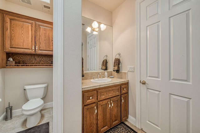 bathroom featuring tile patterned flooring, toilet, and vanity