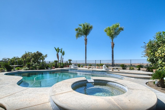 view of swimming pool featuring an in ground hot tub and a patio