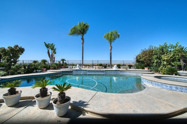 view of pool with an in ground hot tub and a patio