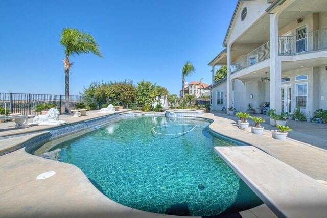 view of pool featuring an in ground hot tub, ceiling fan, and a patio