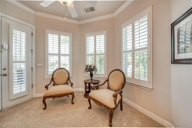 sitting room with ceiling fan, plenty of natural light, and ornamental molding