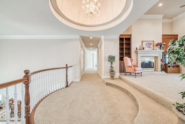 interior space featuring a tray ceiling, ornamental molding, a notable chandelier, and carpet flooring