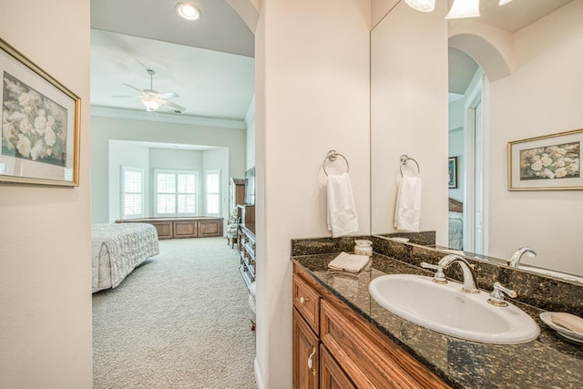 bathroom with ceiling fan, ornamental molding, and vanity