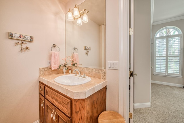 bathroom featuring crown molding and vanity