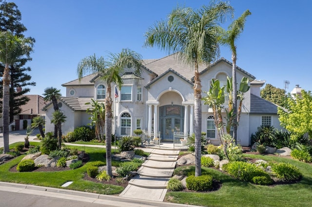 mediterranean / spanish-style home featuring a front yard