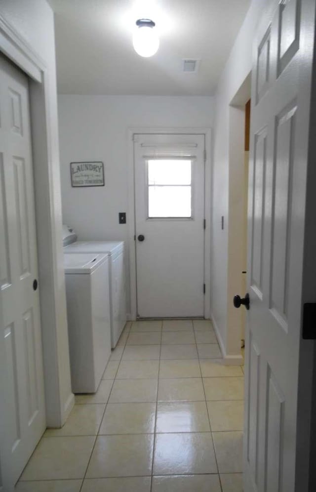 laundry area with light tile patterned floors, independent washer and dryer, and laundry area