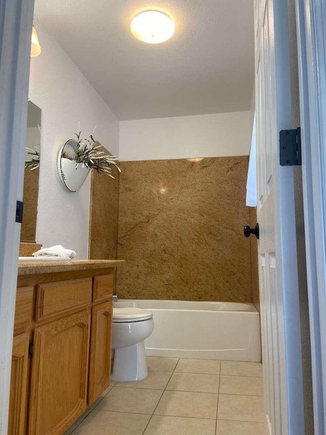 full bath featuring tile patterned floors, toilet, vanity, and washtub / shower combination