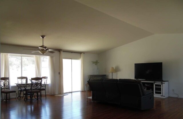 living room with dark wood finished floors, ceiling fan, and lofted ceiling