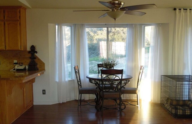 dining space featuring ceiling fan and wood finished floors