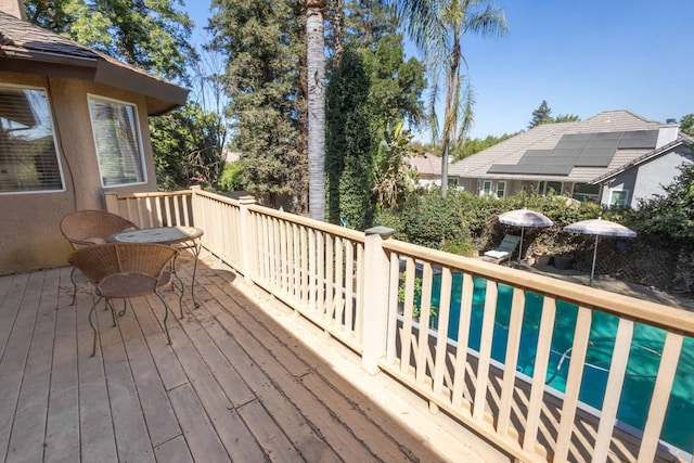 wooden terrace featuring a swimming pool