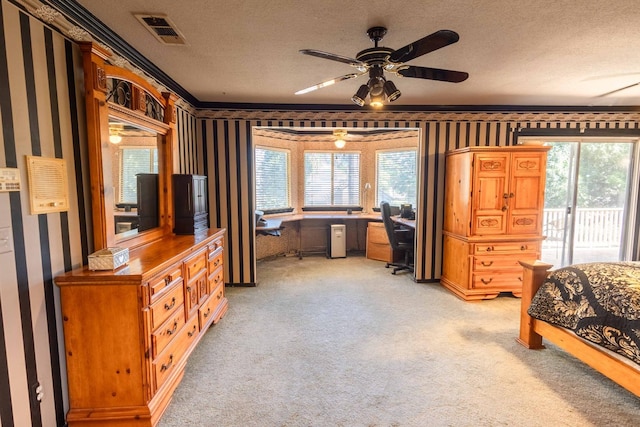 carpeted bedroom with a textured ceiling, multiple windows, and access to exterior