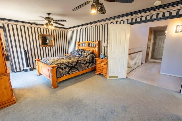 carpeted bedroom with ceiling fan and ornamental molding