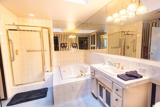 bathroom with vanity and separate shower and tub