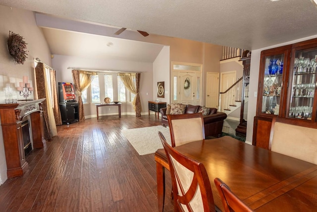 dining area featuring dark wood-type flooring, ceiling fan, a textured ceiling, and lofted ceiling