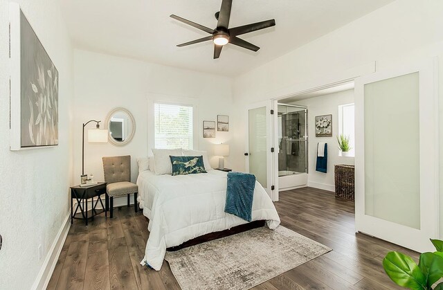 bedroom featuring dark wood-type flooring, baseboards, and ensuite bathroom