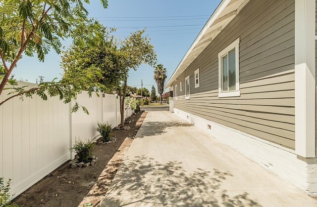 view of home's exterior with crawl space, a patio area, and fence