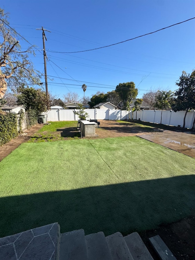 view of yard with a fenced backyard