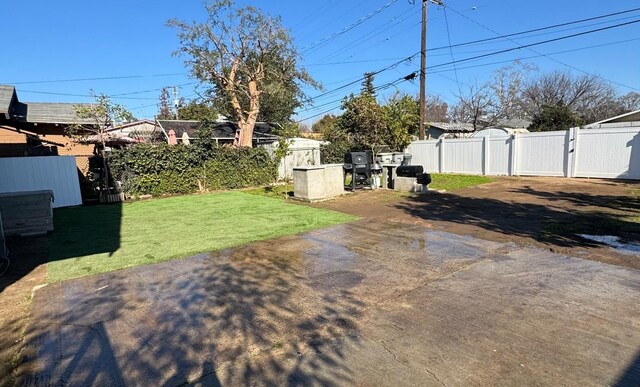 view of yard featuring a gate, a patio area, and fence