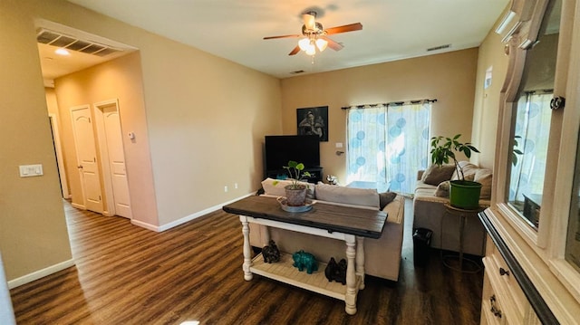 living room featuring dark wood-style floors, baseboards, and visible vents