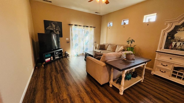 living room with visible vents, dark wood-style flooring, a ceiling fan, and baseboards