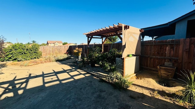 view of yard featuring a fenced backyard, a pergola, and a patio