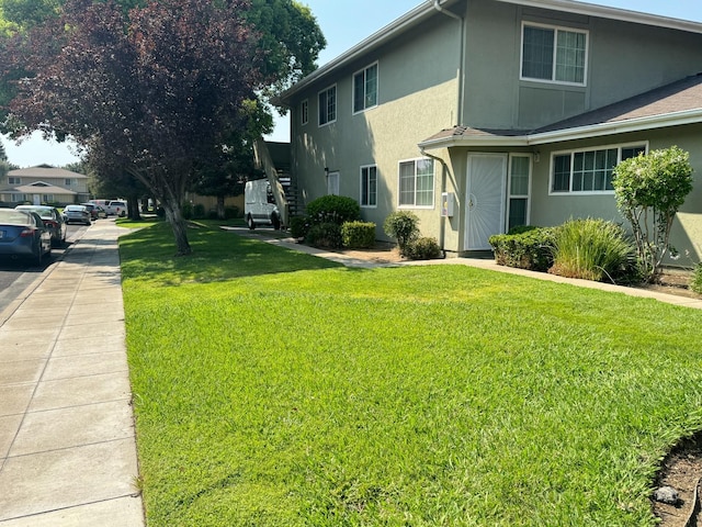 view of side of home featuring a lawn