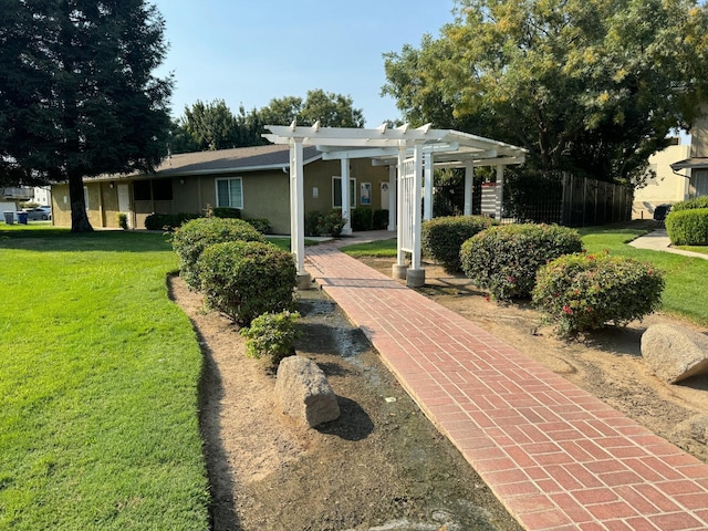 exterior space featuring stucco siding, a front lawn, and a pergola