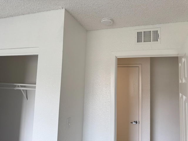2216 Peach Ave Unit 4, Clovis, CA 93612 - unfurnished bedroom featuring a textured ceiling and a closet