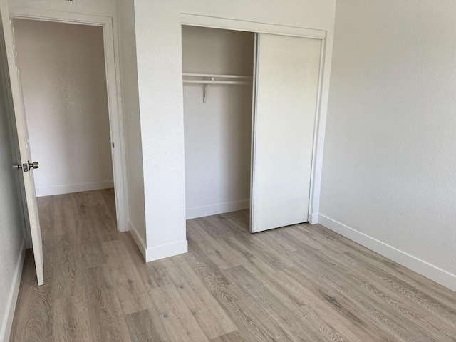 2216 Peach Ave Unit 4, Clovis, CA 93612 - unfurnished bedroom featuring a closet and light wood finished floors