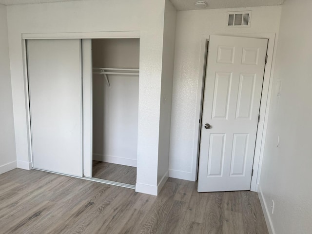 2216 Peach Ave Unit 4, Clovis, CA 93612 - unfurnished bedroom with wood finished floors and a closet