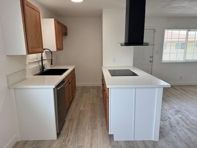 kitchen featuring range hood, black electric stovetop, light countertops, stainless steel dishwasher, and a sink