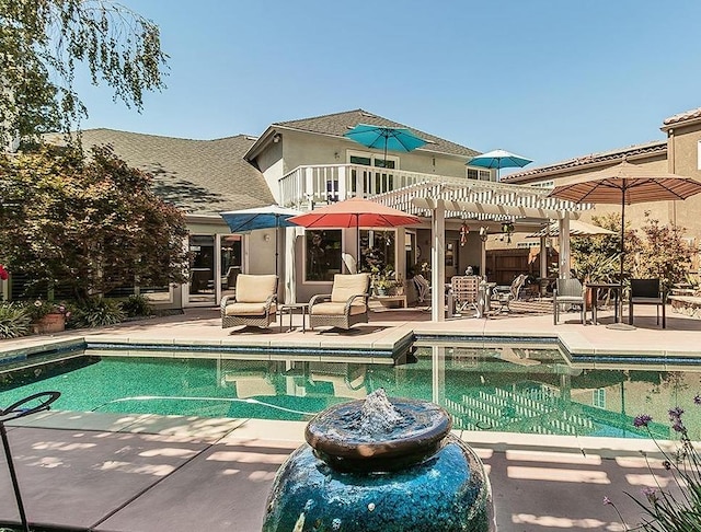 view of swimming pool with a patio and a pergola