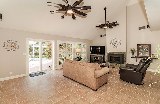 living room with ceiling fan, light tile patterned floors, and high vaulted ceiling