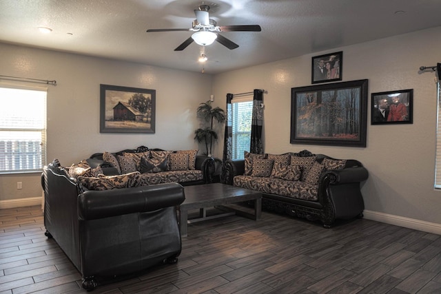 living room with ceiling fan, dark hardwood / wood-style floors, and a textured ceiling