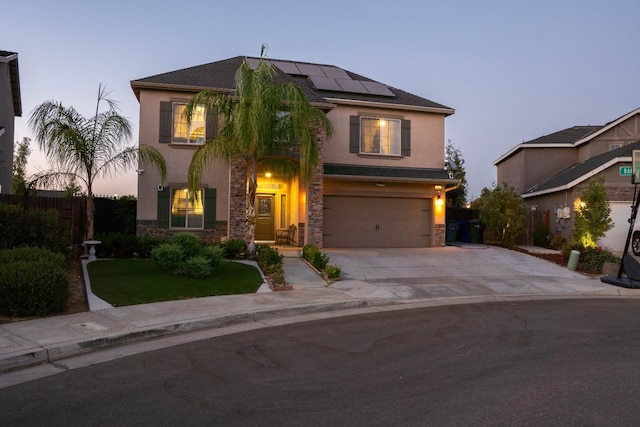 view of front of property with a yard, a garage, and solar panels