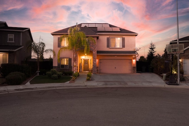 view of front facade with solar panels and a garage