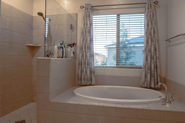 bathroom featuring independent shower and bath