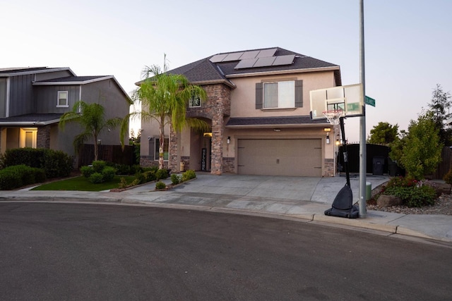 view of front facade featuring a garage and solar panels