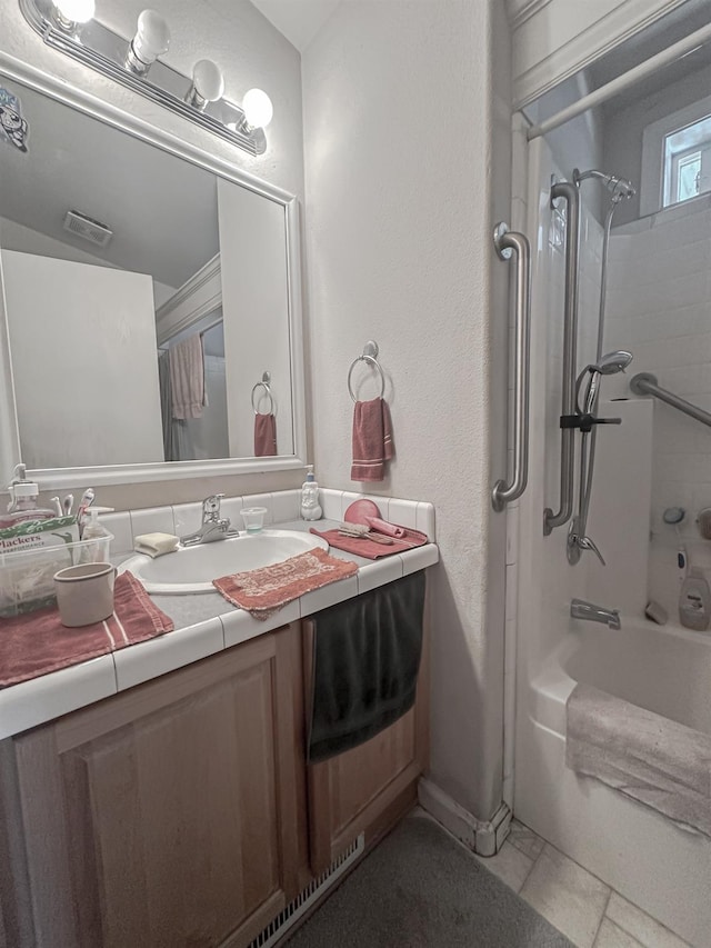 bathroom with vanity and bathing tub / shower combination