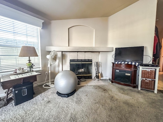 living room featuring a tiled fireplace