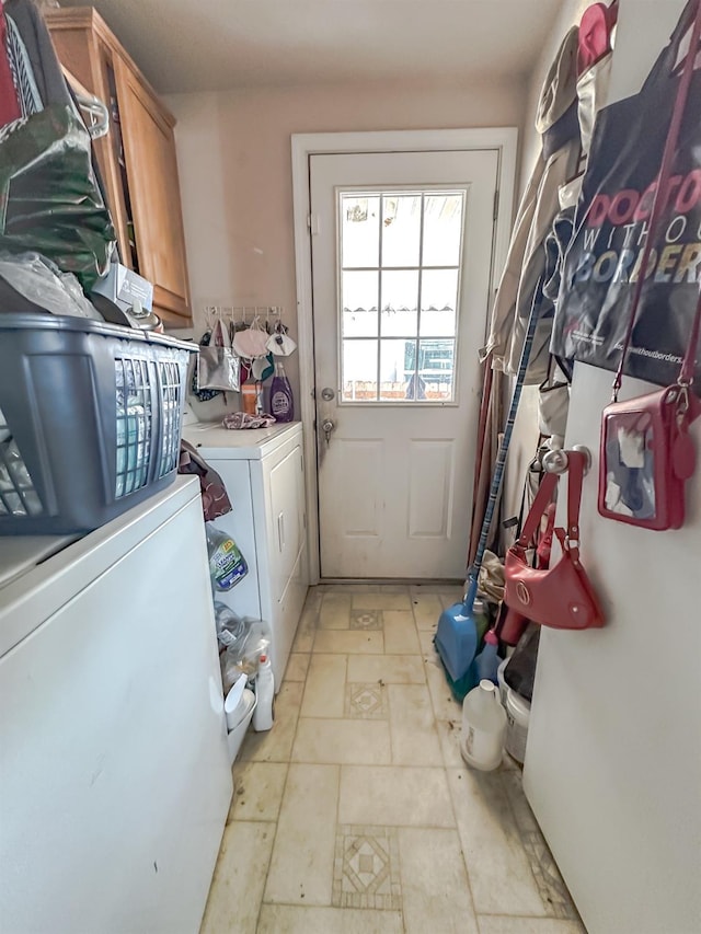 laundry area with cabinets and independent washer and dryer